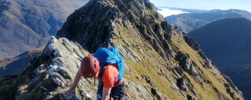 A client scrambling along The Forcan Ridge on a beautiful day.