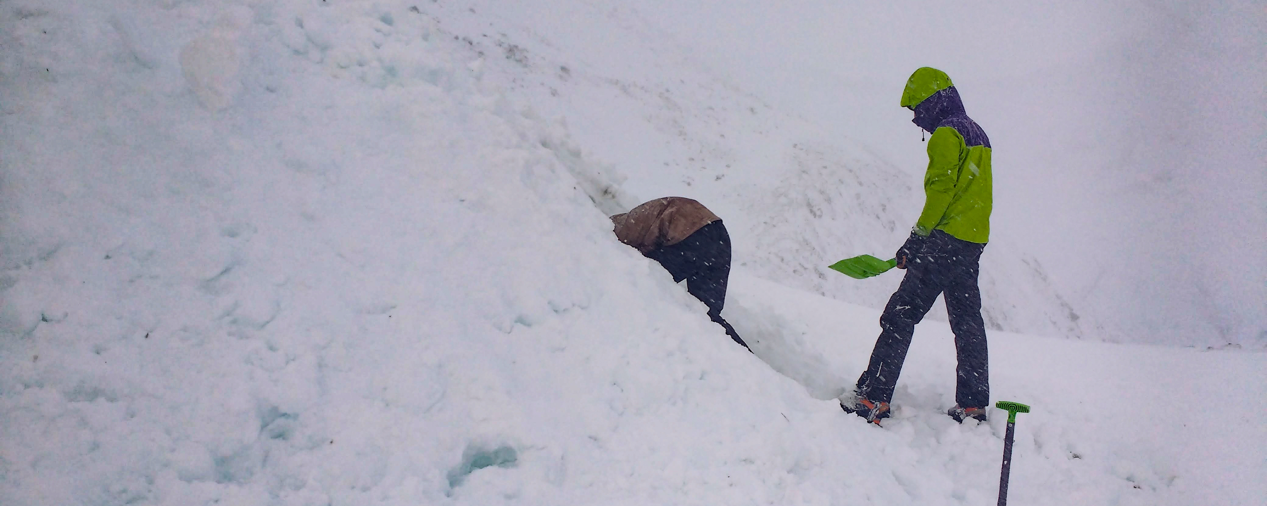 Two People Digging A Snowhole